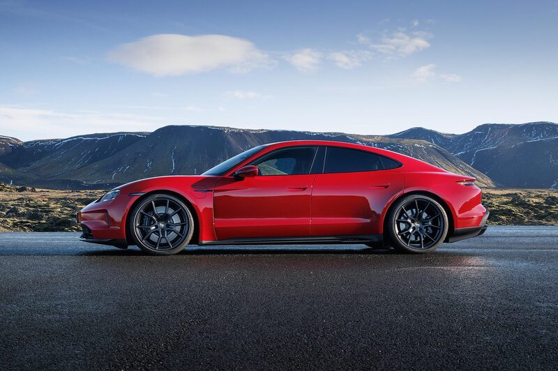 Porsche Taycan GTS in red, side profile on a wet lava-field road in Iceland